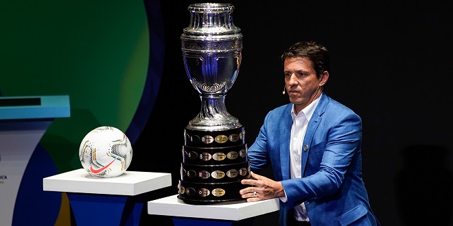 Stats Perform - (191205) -- BEIJING, Dec. 5, 2019 (Xinhua) -- Brazilian former football player Juninho Paulista presents the Copa America trophy on the stage during the draw for the 2020 Copa America football tournament in Cartagena, Colombia, Dec. 3, 2019. (Photo by Jhon Paz/Xinhua)
