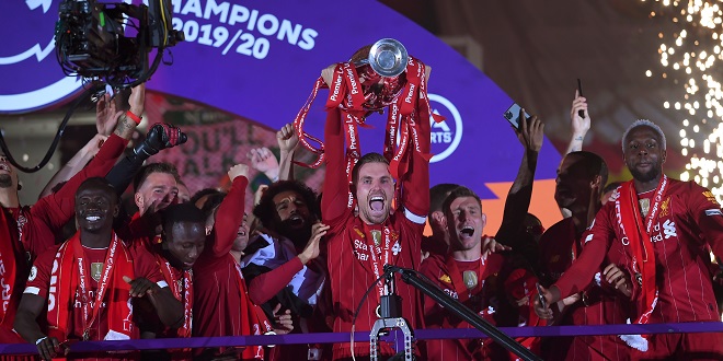 Liverpool's Jordan Henderson celebrates with the Premier League trophy after the Premier League match at Anfield, Liverpool.