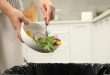 Food being pushed into a bin