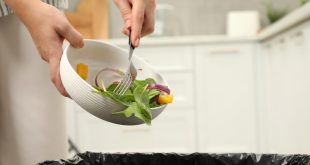 Food being pushed into a bin