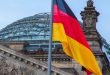 The German flag waiving in front of the Reichstag
