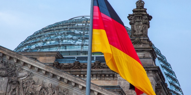 The German flag waiving in front of the Reichstag