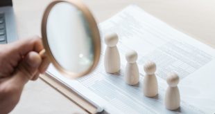 four figures under magnifying glass