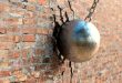 A wrecking ball hitting a wall