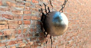 A wrecking ball hitting a wall