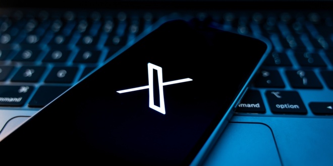 A phone showing the X app, the social media platform which has just partnered with Polymraket