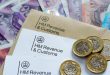 An image of HMRC rax forms and pound coins and notes, symbolising betting tax