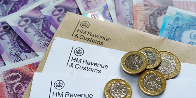 An image of HMRC rax forms and pound coins and notes, symbolising betting tax
