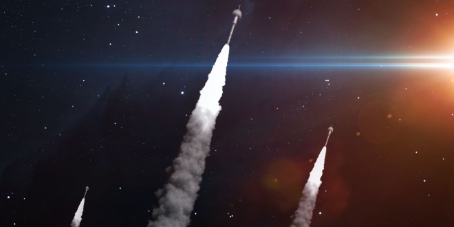 three rockets launching into space