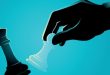 A hand knocks a king chess piece of a board, symbolising M&A battles like the one between Betr and MIXI over PointsBet Australia