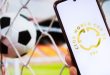 FIFA CLUB WORLD CUP logo on phone in front of football goal