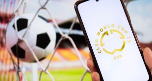 FIFA CLUB WORLD CUP logo on phone in front of football goal