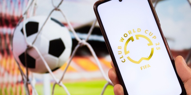 FIFA CLUB WORLD CUP logo on phone in front of football goal