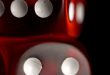 Red dice on black background