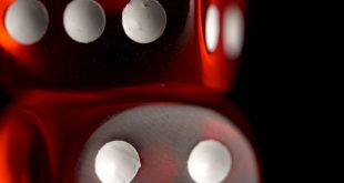 Red dice on black background