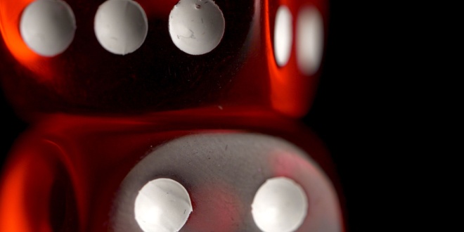 Red dice on black background