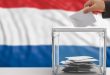 A polling station with the Dutch flag in the background