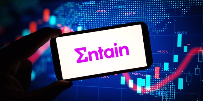 The Entain logo on a backdrop of an increasing stock