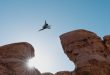 A man leaping between rocks