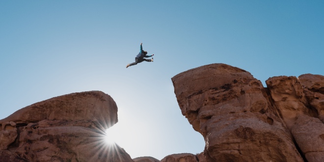 A man leaping between rocks