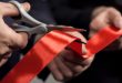 A ribbon being cut with scissors