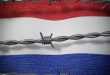 Dutch flag with barbed wire infront
