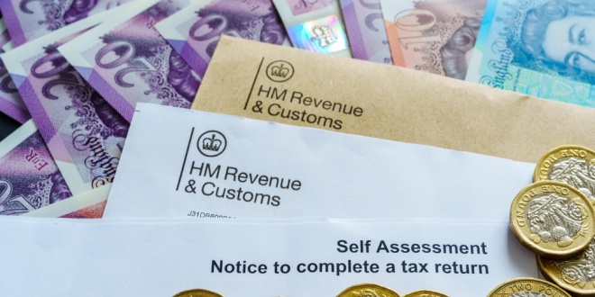 HMRC envelopes next to UK pound notes and coins