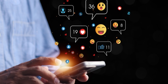 man on phone with emojis