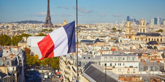 Paris with flag of France in foreground, FDJ United being a French company and operator of the country's National Lottery