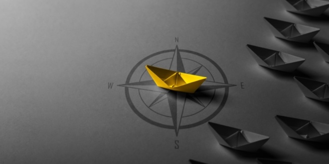 Paper boat on a compass, symbolic of a strategy - like the one unveiled by the IBIA, the International Sports Integrity Association