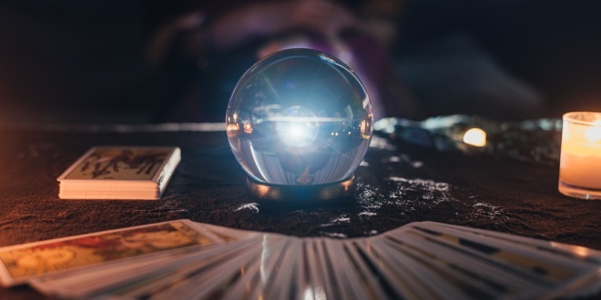 A crystal ball and tarot cards, used to make predictions of the future