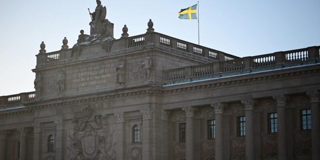 The Swedish flag flying over the Rikstag, the country's parliament