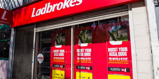 A Ladbrokes betting shop with the shutters down.