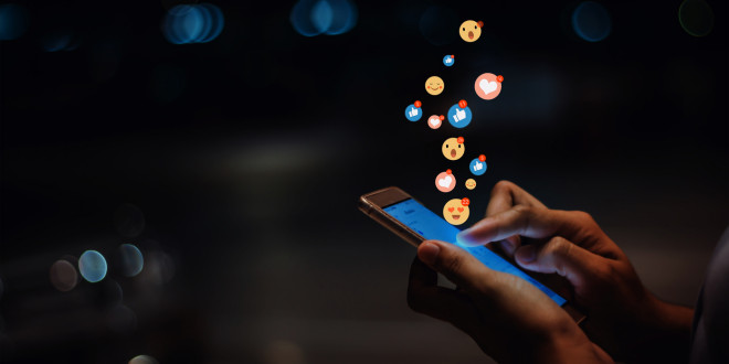 person on phone with social media icons