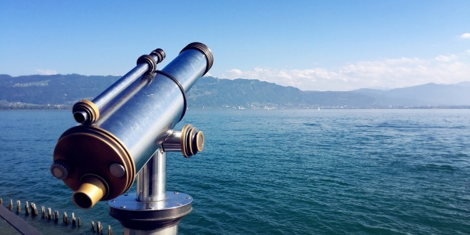 A telescope looking out onto a coastal horizon, symbolising Sportradar's business vision