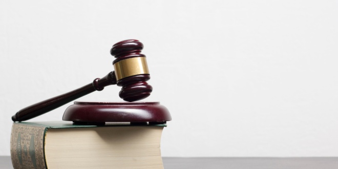 A gavel and legal book, symbolising enforcement actions