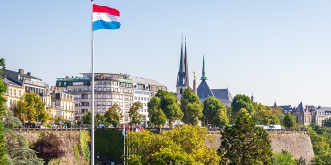 Landscape of Luxembourg with flag in foreground