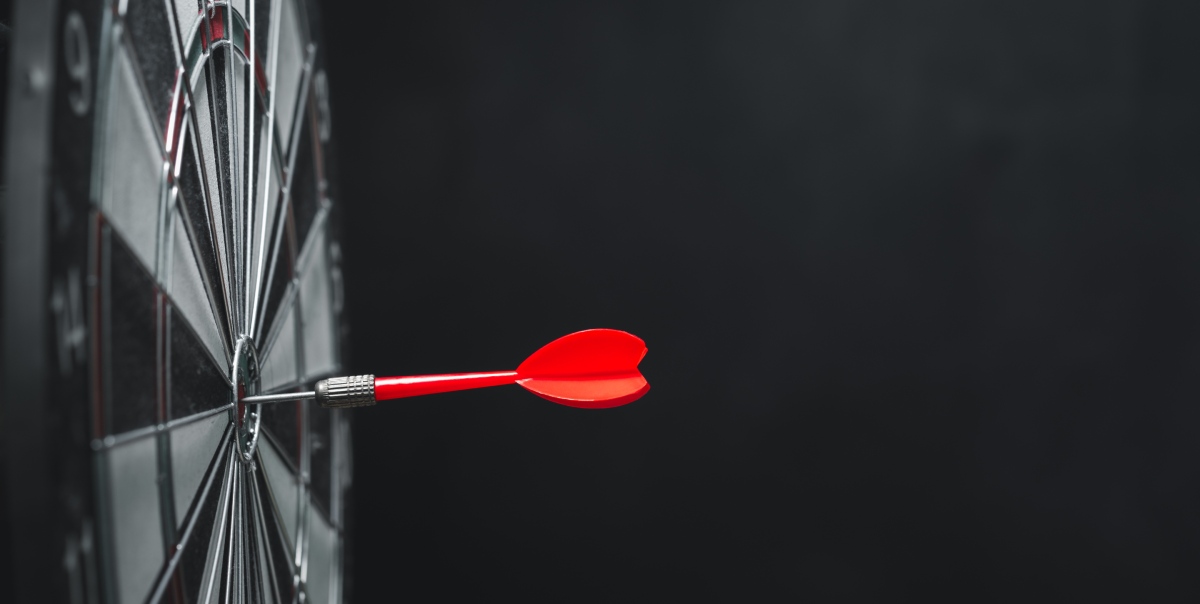 A dart hits the bullseye, reflecting how proper marketing can boost sports betting.