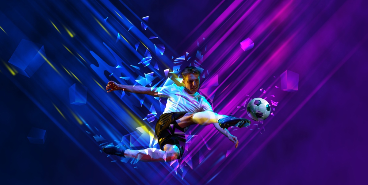 A football player strikes a football in neon lighting, reflecting on Delasport's sportsbook analysis.