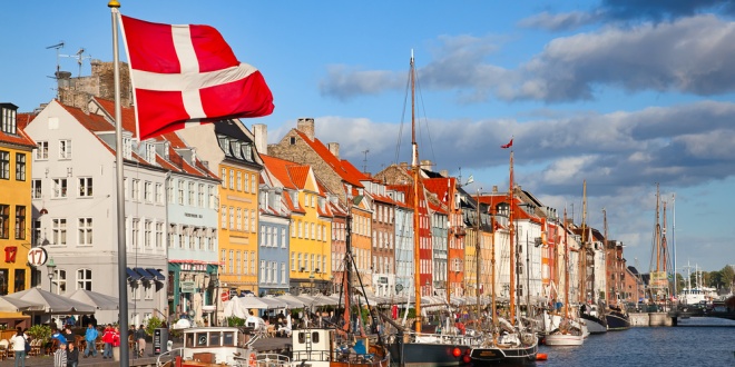 Flag of Denmark flying over a harbour