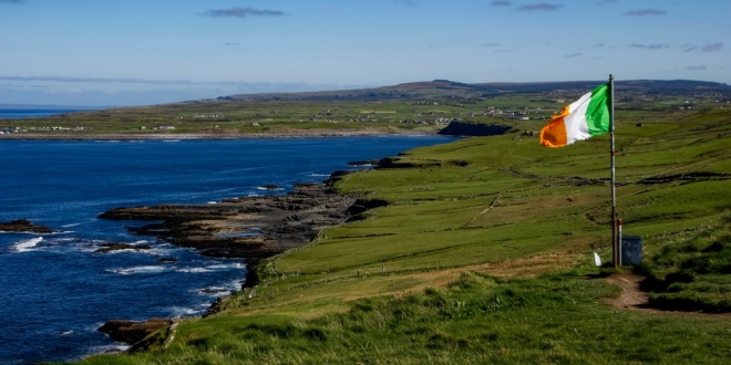 Flag of Ireland flying on the coast