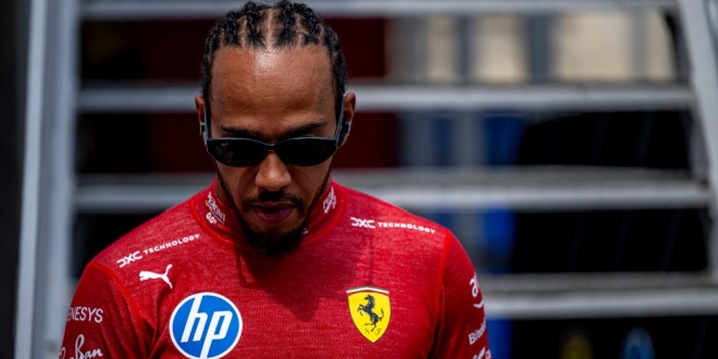 Ferrari driver and seven-time F1 drivers champion Lewis Hamilton wearing his team jersey