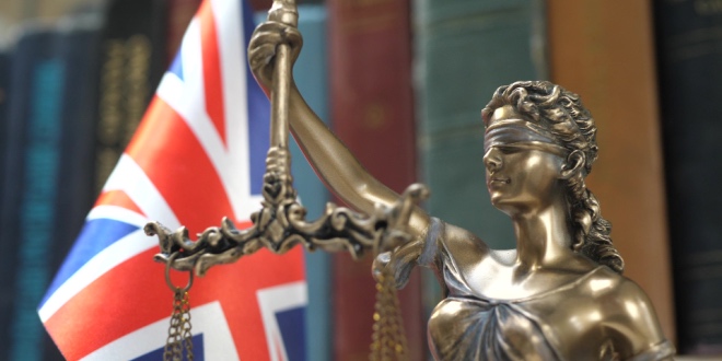 Scales of justice with UK flag in background, symbolising the British court where Betfair secured a favourable ruling