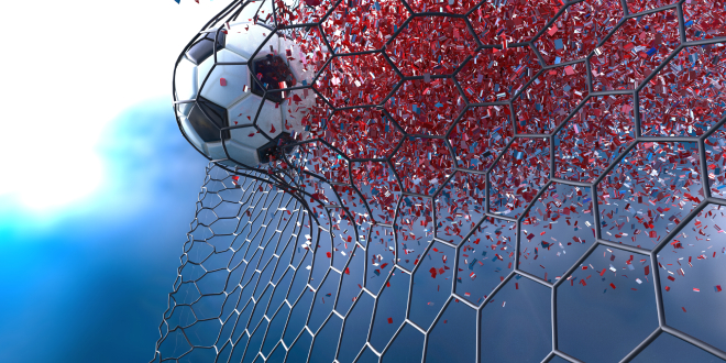 A football crashes into the goal's net.