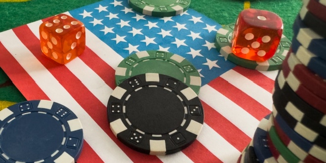 Casino chips and dice on an American flag, symbolic of Flutter's FanDuel Casino