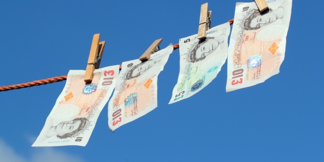 Pound notes hanging on a clothes line, symbolising the money laundering risks faced by the Isle of Man gambling industry