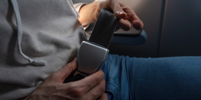 plane passenger experiencing turbulence, representing evoke going through a turbulent period as it announces its FY25 results will come on 29 April
