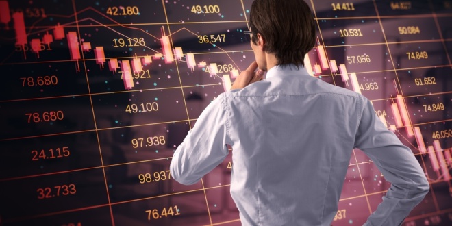 Investor looking at a graph, concept of predictions markets - the space which SOFTSWISS has just entered