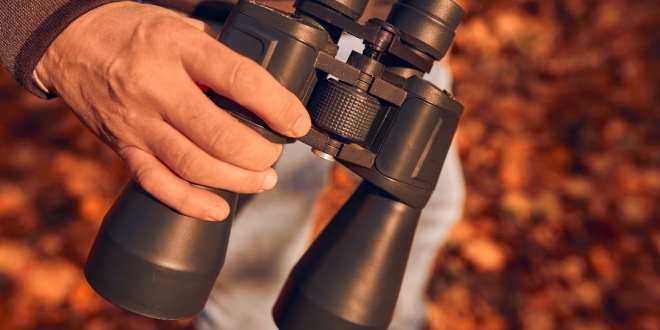 A man holding binoculars