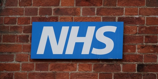 the NHS logo on the side of a hospital building